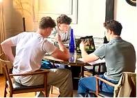 Three students working together around a table